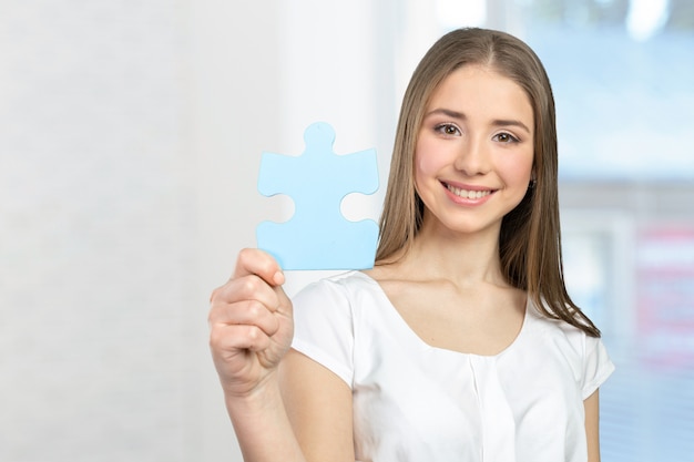 Businesswoman holding puzzle pieces