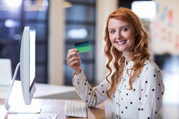 Businesswoman holding smart card in office