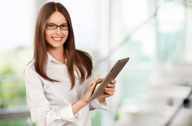 Businesswoman holding tablet pc isolated