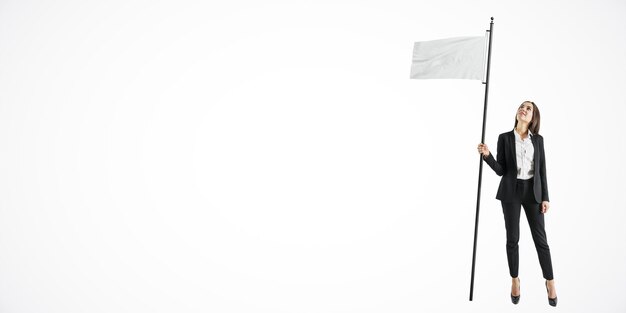 Photo businesswoman holding white flag looking up isolated on white background