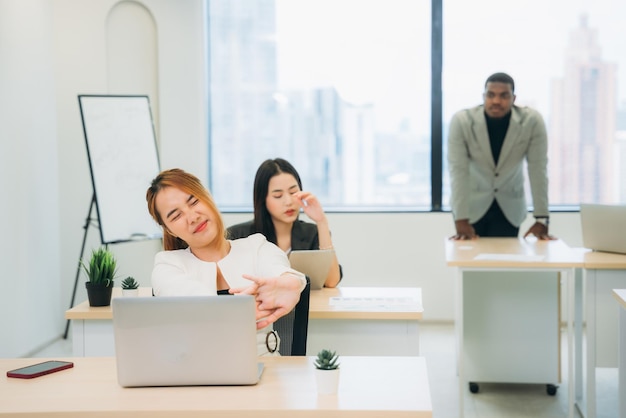 A businesswoman is working in an office and feeling lazy