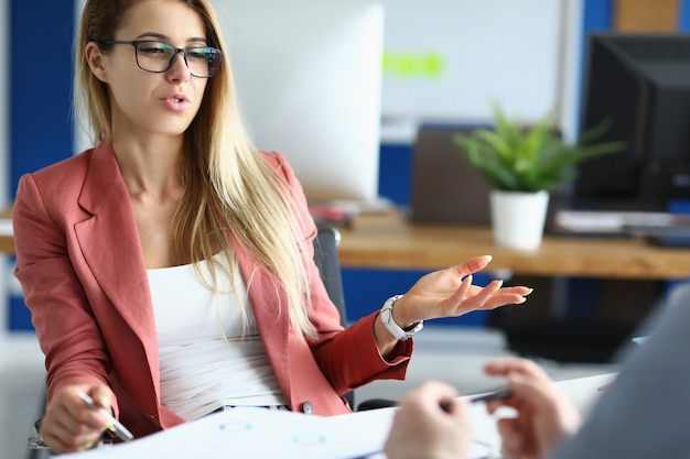 Businesswoman in office communicates with colleague at work. Business consulting for small business concept