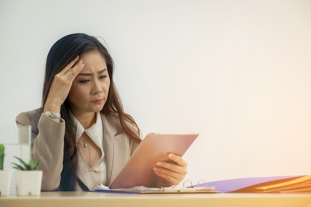 Businesswoman in office working on digital tablet