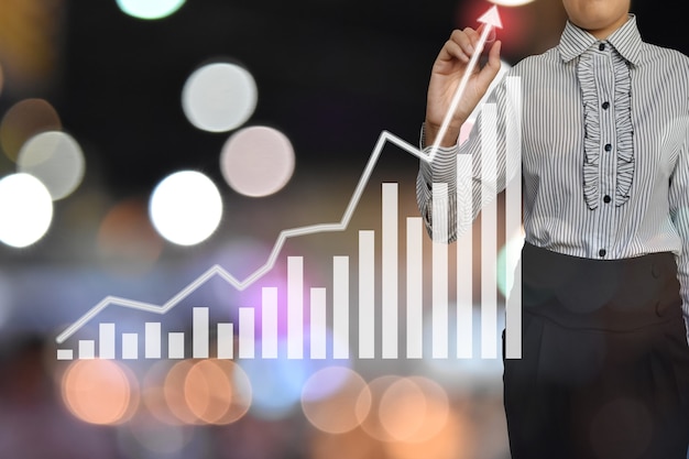 Businesswoman pointing at growth graph for business