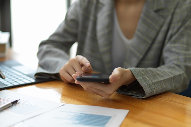 Businesswoman professional manager working on mobile phone in office workspace