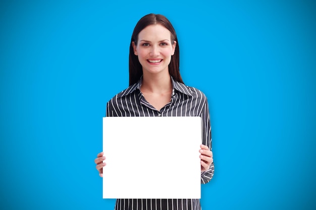 Businesswoman showing card against blue background with vignette