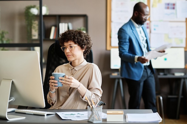 Businesswoman sitting at her workplace at office