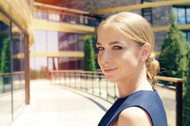 Businesswoman standing next to her office in the morning