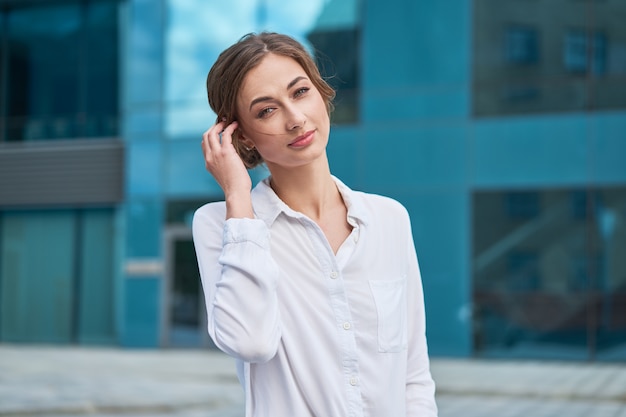 Businesswoman standing outdoor corporate building