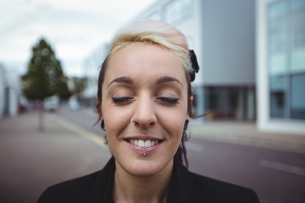 Businesswoman standing with eyes closed