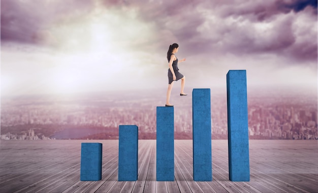 Businesswoman stepping up against bar chart depicting growth