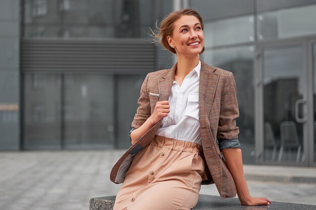 Businesswoman successful woman business person standing arms crossed outdoor corporate building exterior