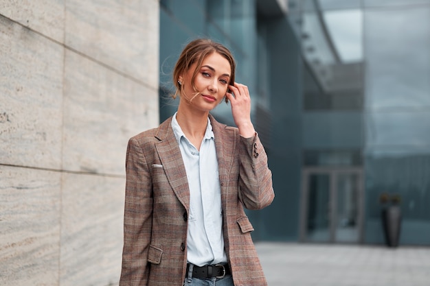 Businesswoman successful woman business person standing outdoor corporate building exterior. Pensiv caucasian confidence professional business woman middle age