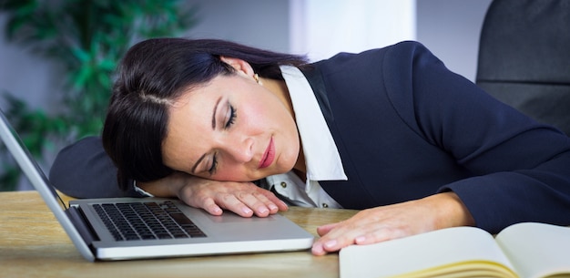 Businesswoman taking a nap on her desk