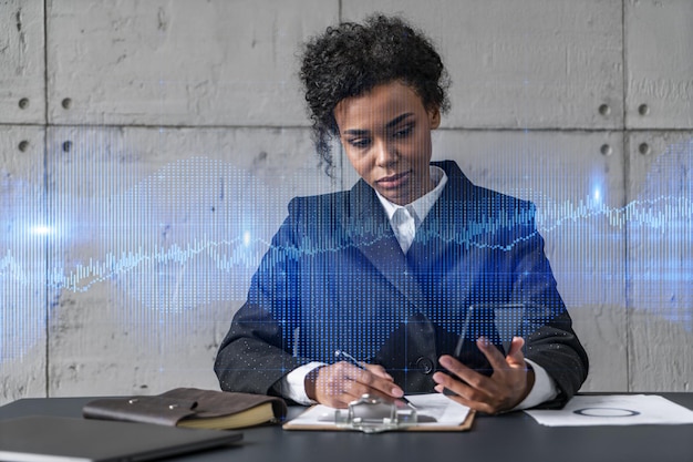 Businesswoman taking notes and forex graph hologram Double exposure Business technology online trading stock market solution concept