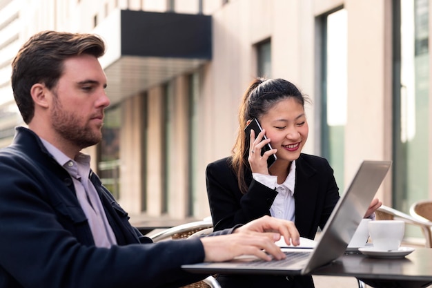 Businesswoman talking by phone in a work meeting