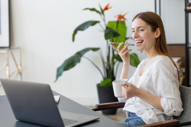 Businesswoman talking on mobile phone while working at home office