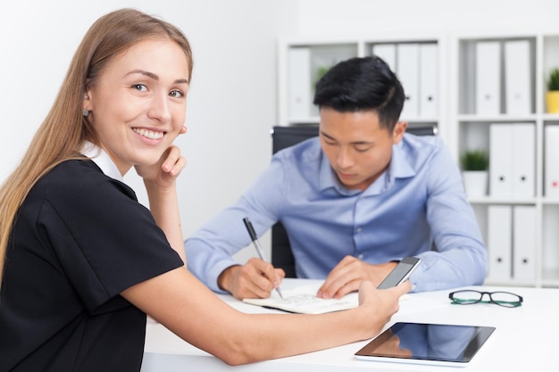 Businesswoman talking on phone in office