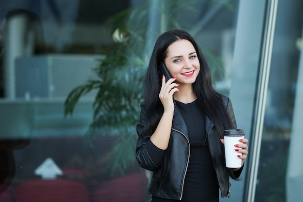 Businesswoman Using Digital Smartphone and Drink Coffee Near Beside Office Building