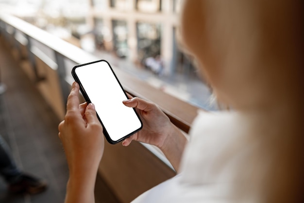 Businesswoman using her mobile phone in the balcony