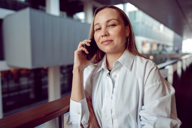 Businesswoman using her mobile phone in the balcony