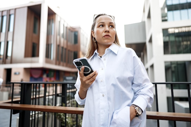 Businesswoman using her mobile phone in the balcony