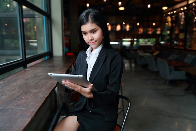 Businesswoman using laptop computer on table in cafe