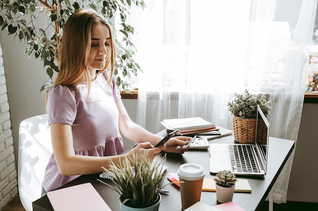 Businesswoman using mobile phone in modern office