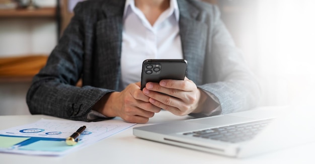 Businesswoman using mobile phone tabletCloseup on blurred background