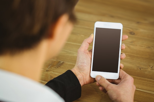 Businesswoman using phone at desk