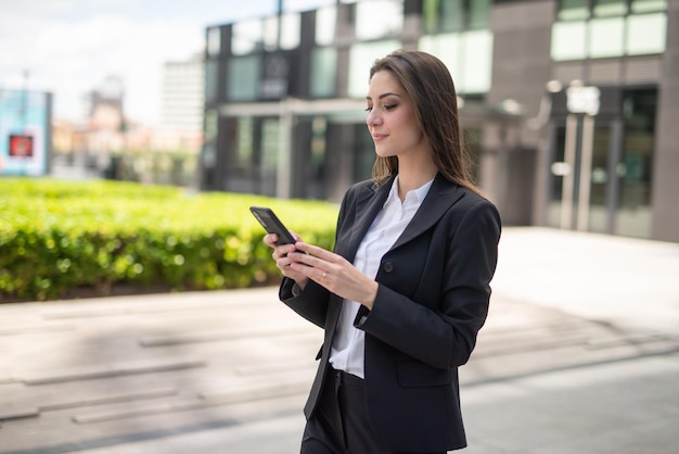 Businesswoman using a smartphone outdoor