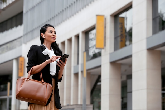 Businesswoman waiting outside for her taxi