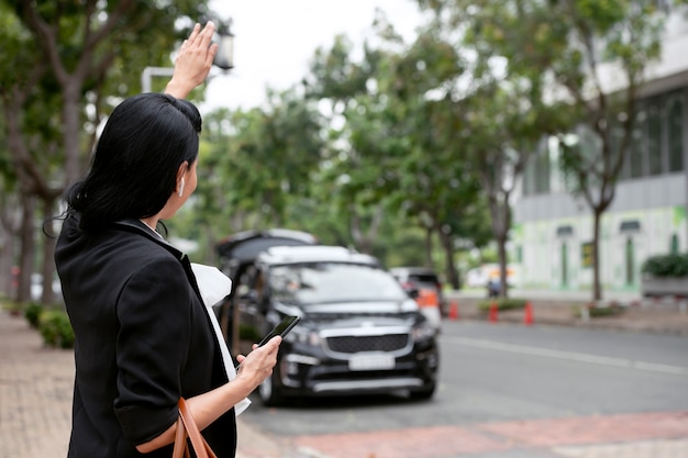 Businesswoman waiting outside for her taxi