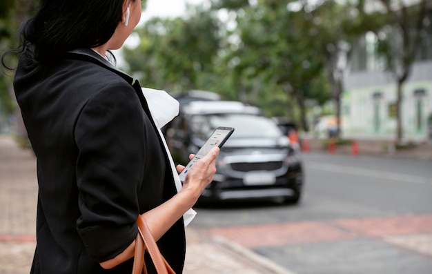 Businesswoman waiting outside for her taxi