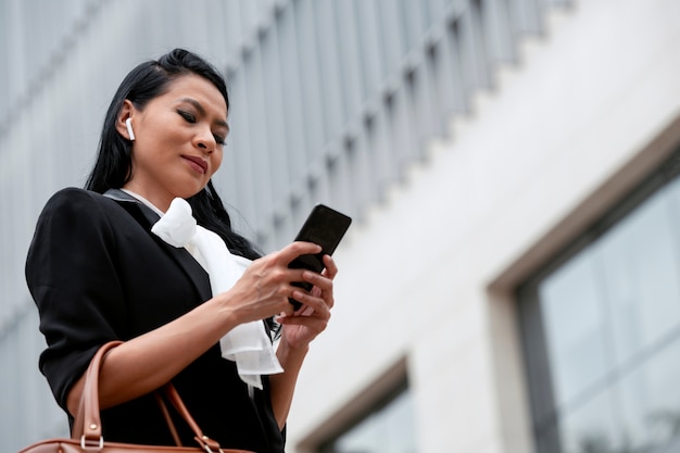 Businesswoman waiting outside for her taxi