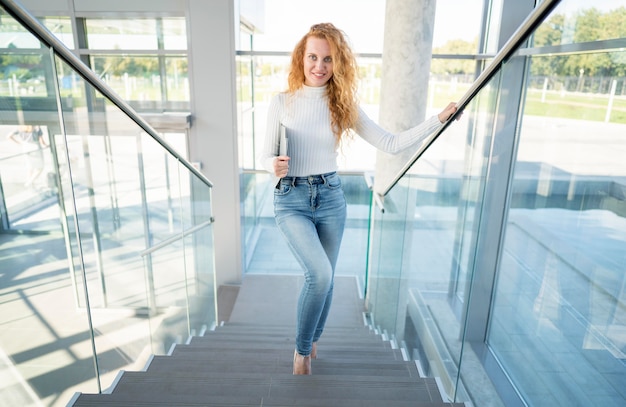 Businesswoman walking the stairs front view