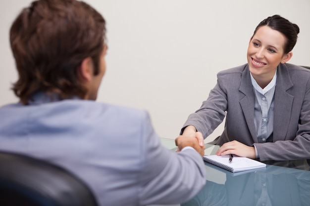 Businesswoman welcomes customer in her office