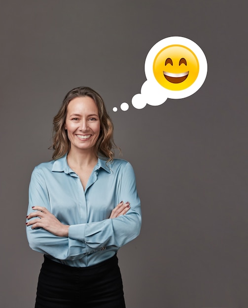 Businesswoman with arms crossed on gray Thinking with a happy face.