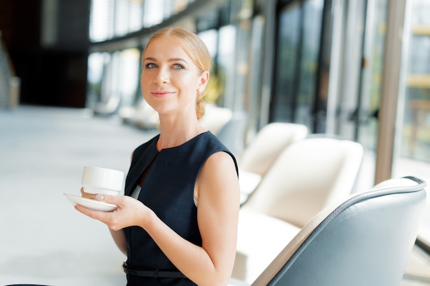 Businesswoman with coffee or tea cup