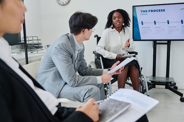 Businesswoman with disability presenting her report