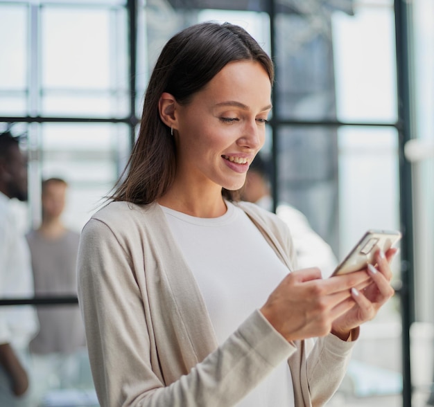 Businesswoman with phone in modern office