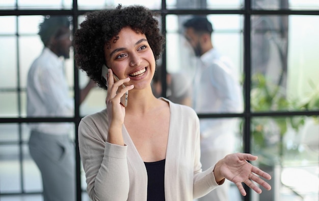 Businesswoman with phone in modern office