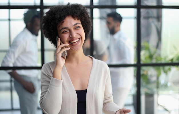 Businesswoman with phone in modern office