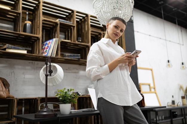 A businesswoman with a short haircut during a coffee break relaxes in the office