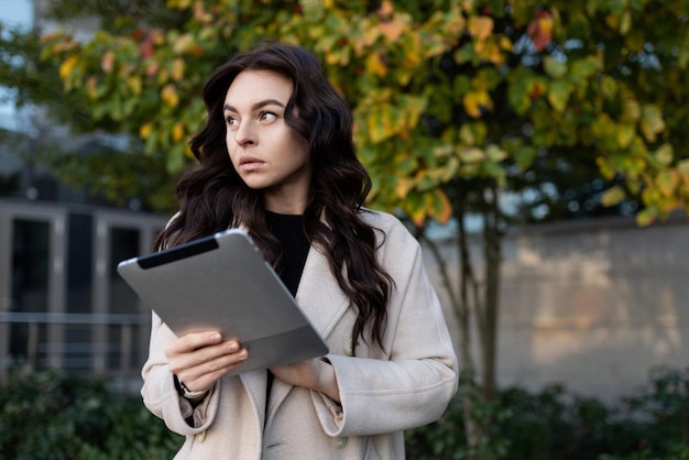 Businesswoman with a tablet on the background of the office center