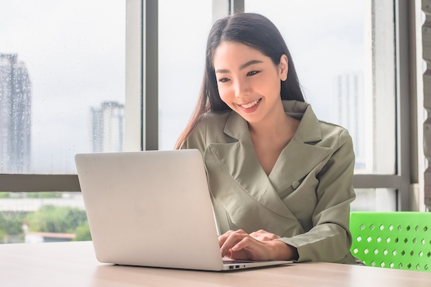 Businesswoman working computer notebook technology sitting office