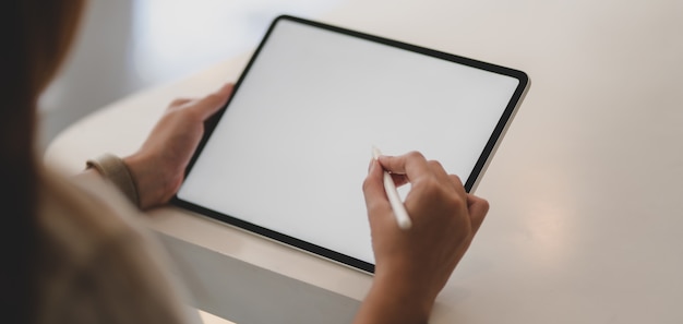 businesswoman working on her project with blank screen tablet