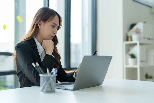 Businesswoman working on a laptop for business information in office