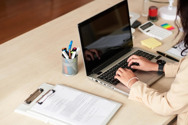 Businesswoman working on laptop at office