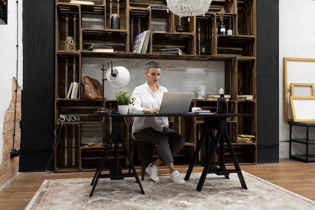 Businesswoman working on startup project sitting with laptop